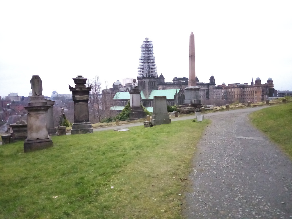 cemetery with numerous headstones and
     cathedral in background