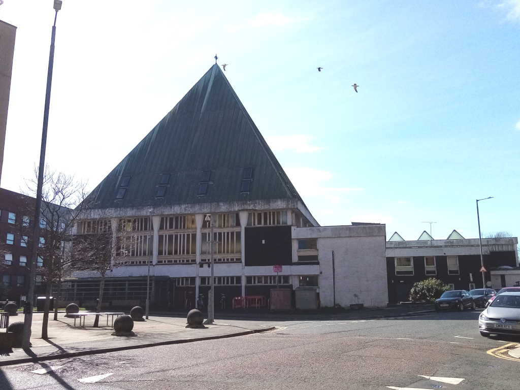 squat building with a pyramid-shaped lead roof